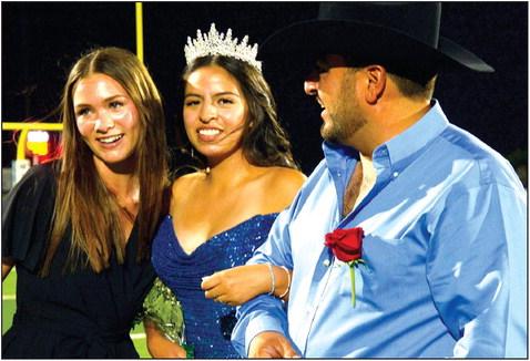 Last year’s Homecoming Queen Kelsey Wetegrove (from left) crowns the 2023 Homecoming Queen Ana Arreola, escorted by her father Marco at Cub Stadium Friday during half-time of the Clifton Cubs versus Rio Vista Eagles football game. Photo courtesy of Chisholm Country magazine