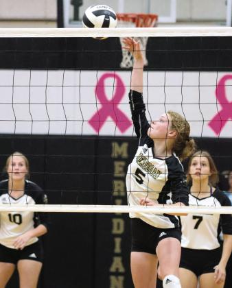 Lady Jacket sophomore Journey Stauffer (5) slams the ball home as senior Cortney Lunsford (7) looks on. Photo by Wendy Orozco courtesy of Brett Voss’ The Sports Buzz