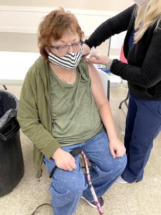 Meridian resident Tammy Anderson receives her first dose of the COVID-19 vaccine during Goodall Witcher's vaccine clinic at Clifton Civic Center last Thursday.