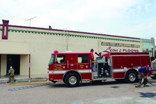 Clifton VFD works quickly to extinguish an AC unit fire on the roof of Leon's Floor Covering in Clifton.