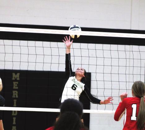 Meridian Lady Jackets go up for the kill during Saturday’s win over the Three Way Lady Indians. Brook DeZavala | Meridian Tribune