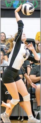 Photo courtesy of The Sports Buzz Lady Jacket junior Journey Stauffer (5) attacks the ball for a kill shot.