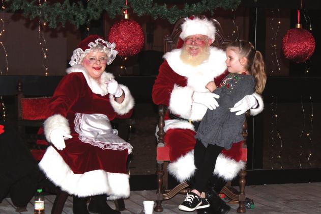 Santa and Mrs. Claus were guests of honor at the Chisholm Trail Plaza following the lighted Christmas parade in Meridian Saturday evening. Kids of all ages lined up to tell Santa how nice they’ve been all year, and to whisper a special wish in his ear. See more photos from the parade on Page 3 inside. Ashley Barner | Meridian Tribune