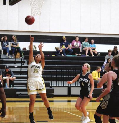 Above, Elina Rosales breaks away for a lay-up. Left, Hannah Olivarri sinks two points. The Lady Jackets came away with a win against Texas Wind last Tuesday. Brook DeZavala | Meridian Tribune