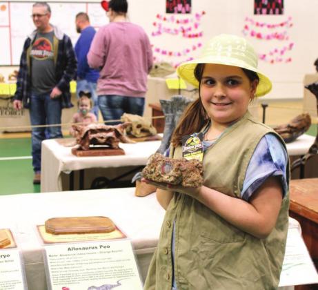 Clifton Elementary School fifth grader Maddie Goolsby is a student ambassador for Dinosaur George and she knows all about what can be learned from fossils like the dinosaur poop she’s holding! Ashley Barner | The Clifton Record