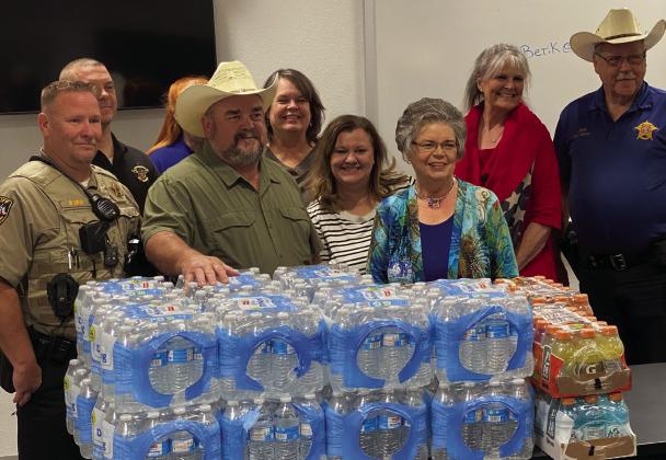 Part of DAR’s day of service, Bosque River Valley chapter members deliver water and Gatorade to local law enforcement. Here they make a considerable donation to the Bosque County Sheriff’s Office Courtesy Photo