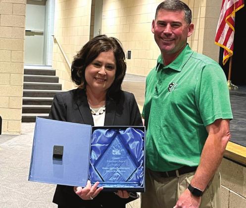 Clifton High School Principal Jimmy Jackson (right) presents Academic UIL Director Gaye Lynn Seawright (left) with the UIL Sponsor Excellence Award at Tuesday’s CISD school board meeting. Ashley Barner | The Clifton Record