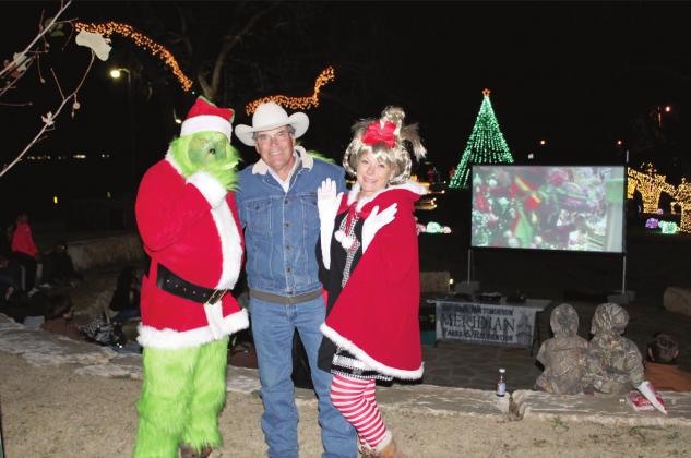 The Grinch (Brett Voss) and Cindy Lou Who (Simone Wichers-Voss) made a special appearance at the Free Outdoor Movie Night at the John A. Lomax Amphitheater Sunday evening. Shown with them is Jack Cameron. Brook DeZavala | Meridian Tribune