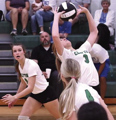 Lady Cub Sydney Fullerton sets the ball up for a play as teammates Kate Humphreys and Carley Caniford look for the assist. Photo Courtesy of Brett Voss’ The Sports Buzz