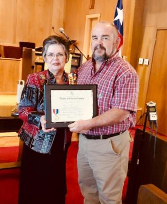 Bosque River Valley Chapter Regent Sue Fielden presents Clifton Pollice Chief and Bosque County Sheriff-elect Trace Hendricks with the second DAR Distinguished Citizen Medal for 2020. Courtesy Photo