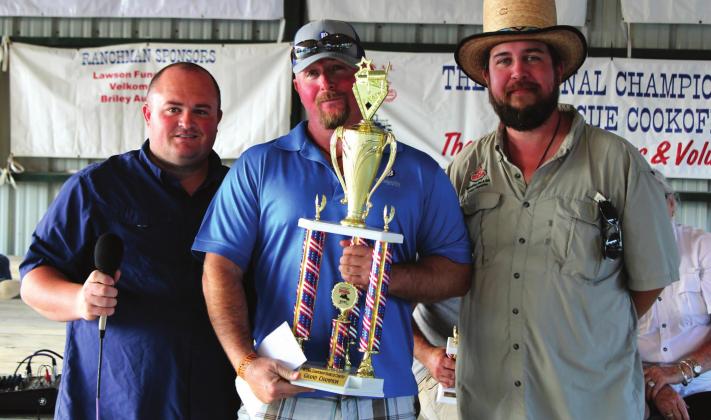 Meridian Mayor Ryan Nieuwenhuis presents BBQ Grand Champion Heath Walden with River Bottom Boys with the Grand Prize at the National Championship BBQ Cookoff. Brook DeZavala | Meridian Tribune