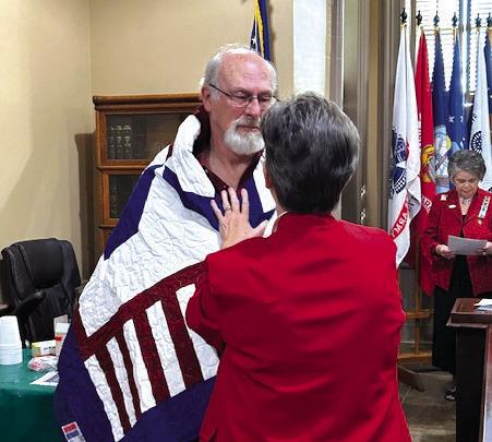 Debbie Stubbs (center, right) bestowed a Quilt of Valor to Vietnam War Veteran Jerry Van Dyke (center, left) during a ceremony commemorating Vietnam Veterans Day on Wednesday, March 27, at the Bosque County Courthouse in Meridian. Photo by Bosque River Valley Chapter, NSDAR