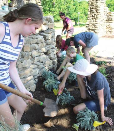 Junior Master Gardeners Rebekah Tyler digs a hole deep enough for Samantha Grelle to place her Texas weather-tolerant plant. Also pictured are Brock Barrett, Piper Boyd, Marilee Harris and teacher Michele Morris. Ashley Barner | The Clifton Record