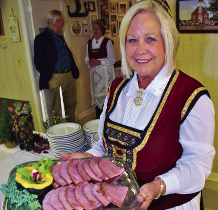 Hostess Kay Owens serves a tastey meat tray during the annual Smorgasbord buffet at Our Savior’s Lutheran Church. Ral Aars | Meridian Tribune