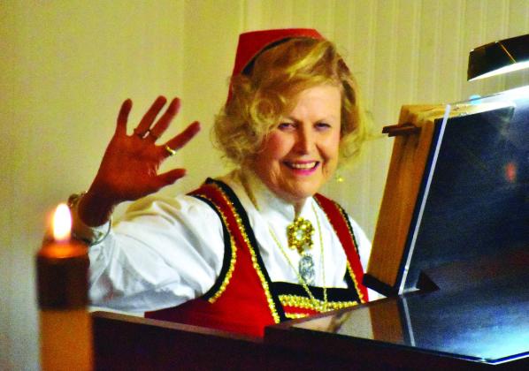 Lifelong member Patsy Erickson Squyres acknowledges applause from the audience after being recognized as the church organist for 63 years and attending the first Smorgasbord in 1949 as a little girl. Ral Aars | Meridian Tribune