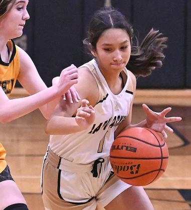 Lady Jacket senior Canyon Stauffer (4) drives the lane for a layup (above left); Junior Journey Stauffer (5) works the ball upcourt (top right); freshman Sarah Rosales (1) battles past defender (above right). Photos courtesy of Brett Voss’ The Sports Buzz