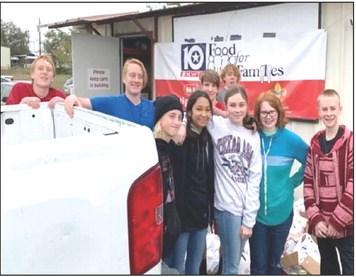 Junior High National Honor Society students from Meridian Independent School District worked through mountains of boxes and bags full of food and got them all shelved during the annual Food for Families Food Drive in Meridian on Friday, November 18. Courtesy Photo by North Bosque Helping Hands