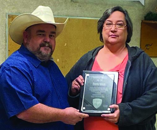 Bosque County Sheriff Trace Hendricks honored Sharon Wilson for her 20-years of service to the sheriff’s department earlier in December 2022. Courtesy Photo By Bosque County Sheriffs Office