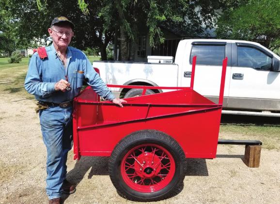 Zack Zacharias is happy with the restoration of the little red trailer found in one of the old barns. Photo Courtesy Genie Ellis Zacharias