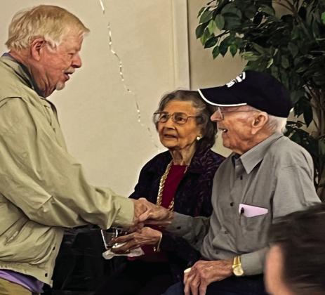 Jerry Godby (right) and his wife Nell (center) welcomed guests to his 100th birthday celebration in Clifton on Saturday, December 17. Nathan Diebenow | The Clifton Record