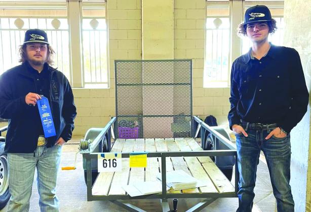 Bradley Kihnel and Carl Williams of Meridian FFA Ag Mechanics show their utility trailer project at the Fort Worth Stock Show where they won a blue ribbon and A+ rating in a competitive race in January 2023. Courtesy Photo By Meridian FFA